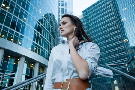 fashionable female model in city, skyscrapers backgroundの写真素材