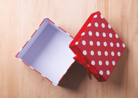 empty red gift box on wooden background, templateの写真素材