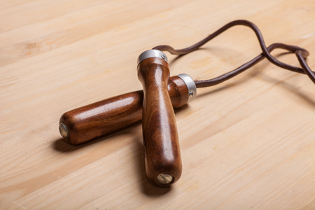 vintage leather jumping rope on wooden backgroundの写真素材