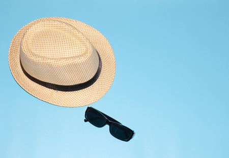 summer hat with sunglasses isolated on blue background, copy-space rightの写真素材