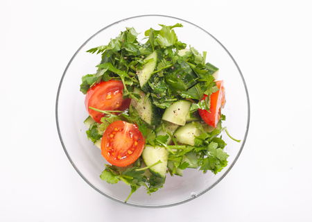 salad in transparency glass bowl isolated on white backgroundの写真素材