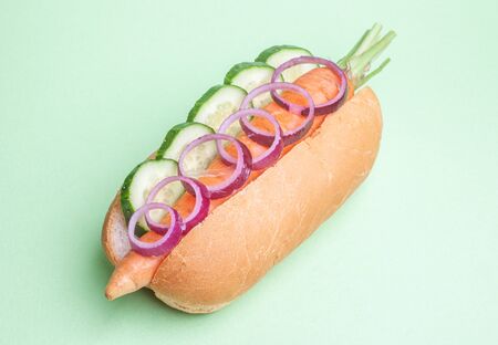 vegan hot-dog - carrot, bun, onion, cucumber, isolated on green backgroundの写真素材