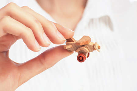 hand holding little toy airplane, transportation business conceptの写真素材