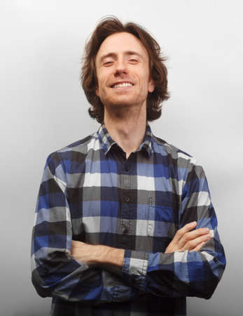 toothy smiling caucasian man in causal shirt isolated on white backgroundの写真素材