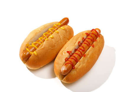 two classic hot dogs with ketchup and mustard isolated on white backgroundの写真素材