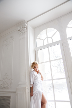 Beautiful girl sexy blonde in lingerie posing in bathroom, interior, apartmentsの写真素材