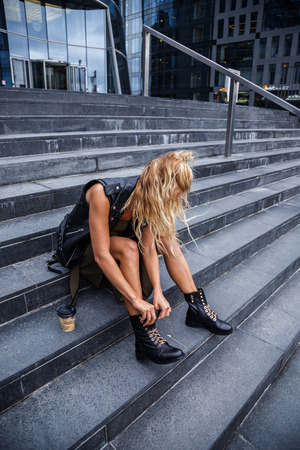 Beautiful blond girl in stylish clothes posing outdoors in the cityの写真素材