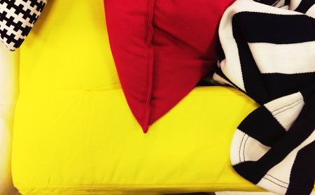 Yellow sofa with black and white blanket and a pillow for living room