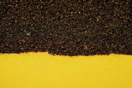 Pile of soil on yellow and black background. Abstract background.