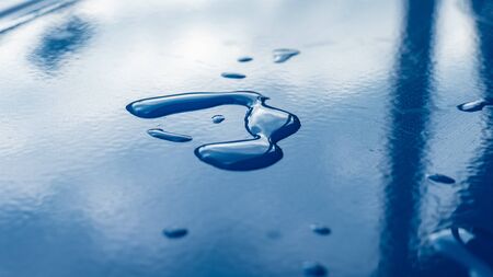 Drop of water on blue tableの写真素材