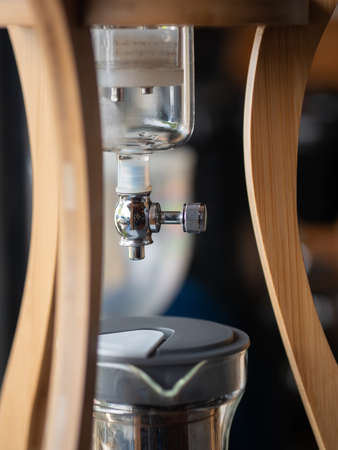 Cold brew coffee tower - Kyoto dripper, focus on stainless valve. drip brewing, filtered, pour-over, cold brew coffee collected in the flask, iced coffee maker.の写真素材