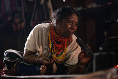 Mae Hong Son, Thailand - September 24, 2020 : Old lawa woman wearing traditional costume with beads necklaces in the house.のeditorial素材
