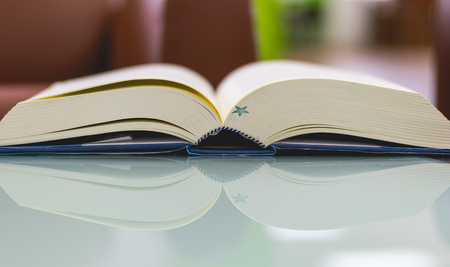 Book on the table with reflection mirror.の写真素材