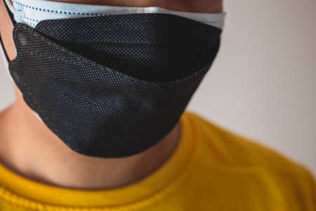 Double masking helps to improve the fit and filtration of first mask. Protection global pandemic of coronavirus. Other name of this disease calls COVID-19.の写真素材