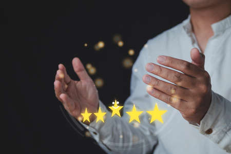 Customer review concept. Among hands, there are five stars for Excellent job. Close up shot with...