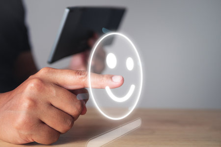Evaluation and satisfaction concept. Someone chooses a smile emotion that is an excellent review with smart keyboard. Medium close up shot with virtual screen.の写真素材