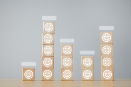 Comparison result of happiness. Even if happiness is more or less, it is happiness. Wood block with smile emoji.の写真素材