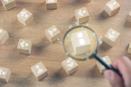 Selection concept. Human Resource Manager chooses new person to join an organization or support a cause. Magnifying glass zooms a cube that is best person.の写真素材