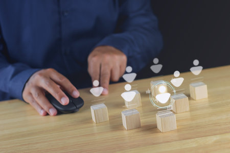 Recruitment concept. Human Resource Manager chooses new people to join an organization or support a cause. Holograms are happened on wood cube.の写真素材