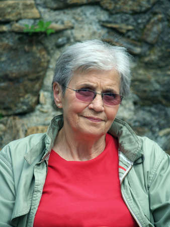 Actice old modern woman with glassesの写真素材