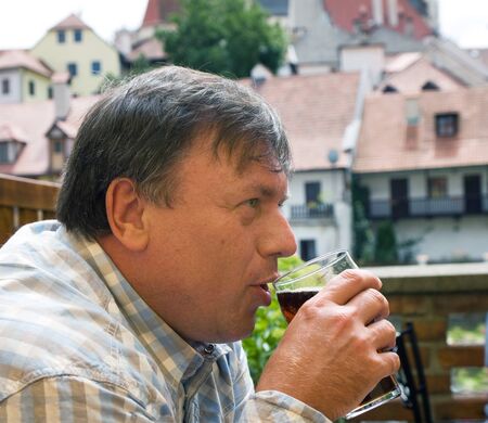 Mature men drinking black beerの写真素材