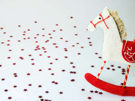 Horse toy in red and white on stars backgroundの写真素材