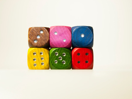 Isolated wooden game dices with numbers in six colorsの写真素材