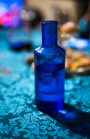 Blue bottle on a tableの写真素材