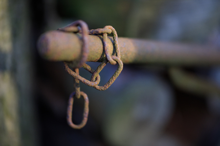 a hanging old rusty chainの写真素材