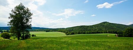 view over the fields and meadows to Gie huebelの写真素材