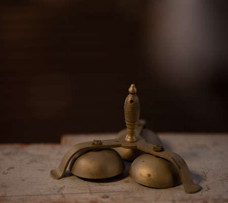 Handbells on table with gloved hands ready to perform.の写真素材