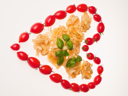 Tomatoes heart with pastaの写真素材