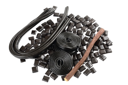 Licorice roots and candies on white backgroundの写真素材