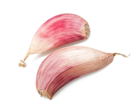 Red garlic cloves isolated on whiteの写真素材