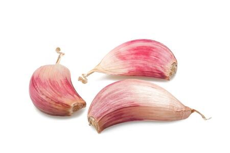 Red garlic cloves isolated on whiteの写真素材