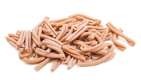 whole wheat strozzapreti italian pasta isolated on whiteの写真素材