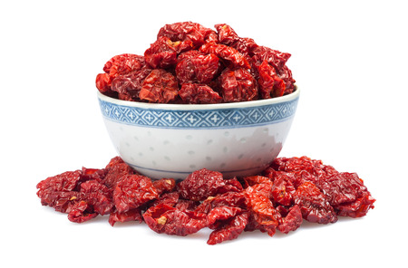 Dried tomatoes in a cup  isolated on white background の写真素材