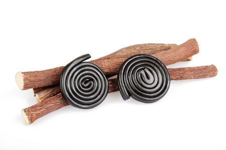 Licorice roots and wheels isolated on whiteの写真素材