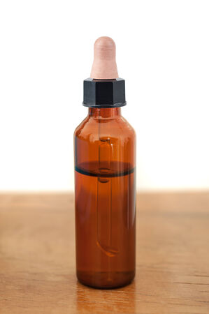 Herbal medicine or aromatherapy dropper bottle on woodの写真素材