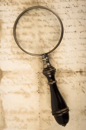 Vintage magnifying glass  on old letter backgroundの写真素材
