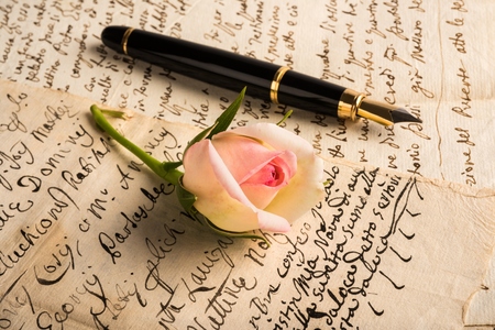 Rose and fountain pen on a lettersの写真素材