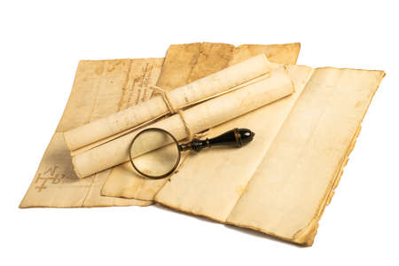Magnifying glass with old sheets isolated on white backgroundの写真素材