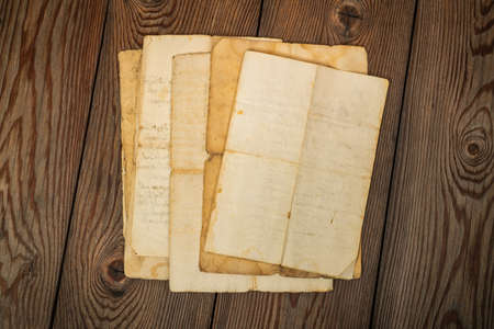 Old sheets stacked on wood backgroundの写真素材