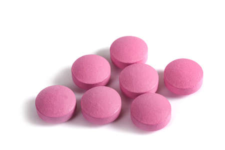 Pink pills group isolated on white background