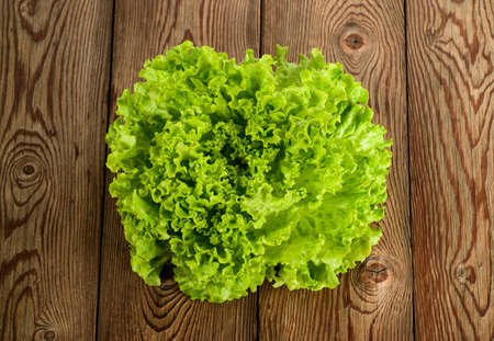 Lettuce bunch on a wood backgroundの写真素材