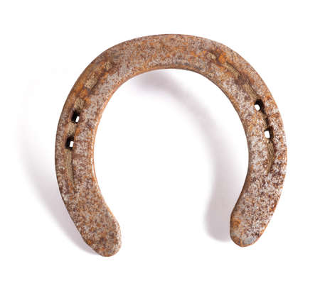Rusty horseshoe isolated on white backgroundの写真素材