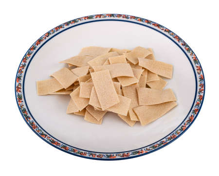 Maltagliati pile pasta isolated on white backgroundの写真素材