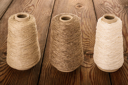Bobbins of yarn  on  wood backgroundの写真素材