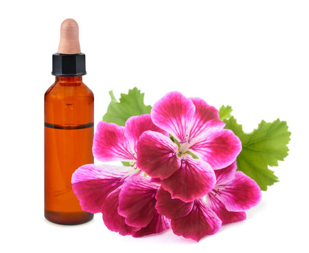 Geranium flowers with bottle with essence  isolated on white backgroundの写真素材
