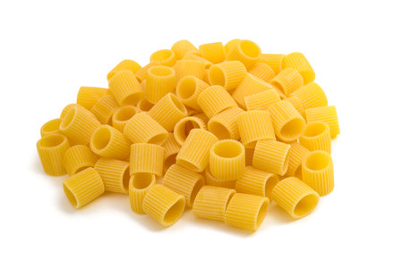 Mezze maniche pasta pile isolated on white backgroundの写真素材